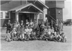 Group of Children and Adults Outside Building