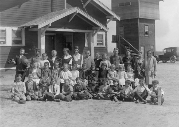 Group of Children and Adults Outside Building